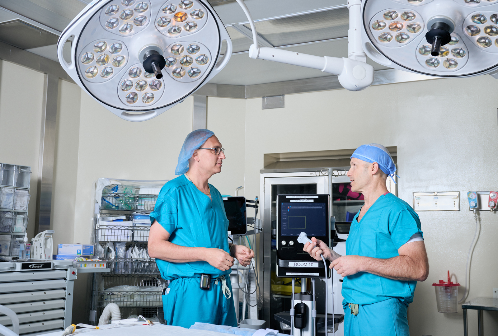 Two healthcare providers talk in an operating room
