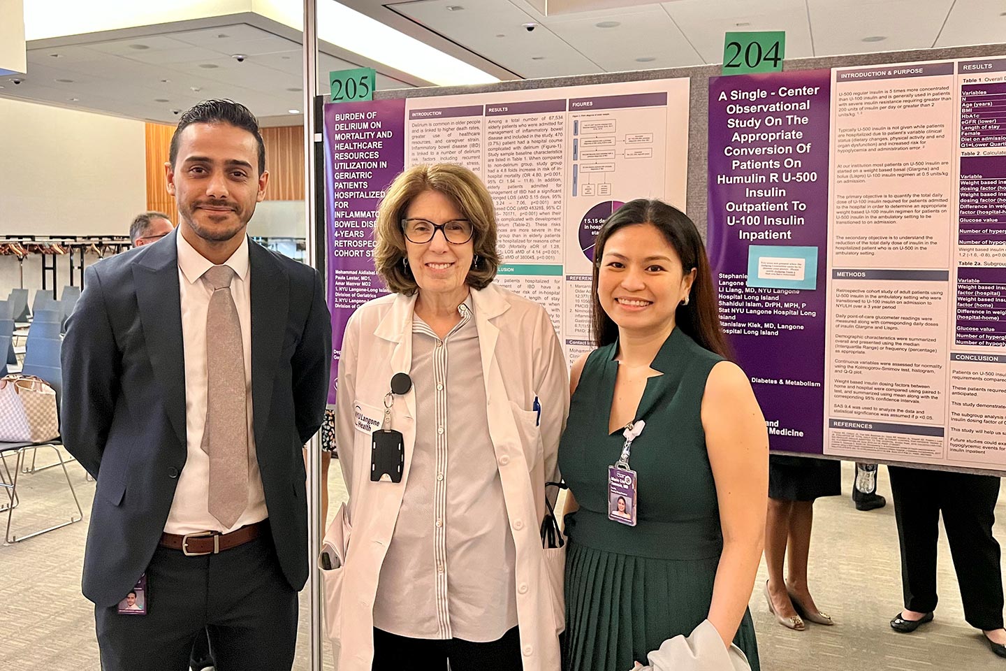 A recent fellow posing with Dr. Lucy O. Macina and Dr. Marie Cris B. Tamesis in front of posters displaying their work