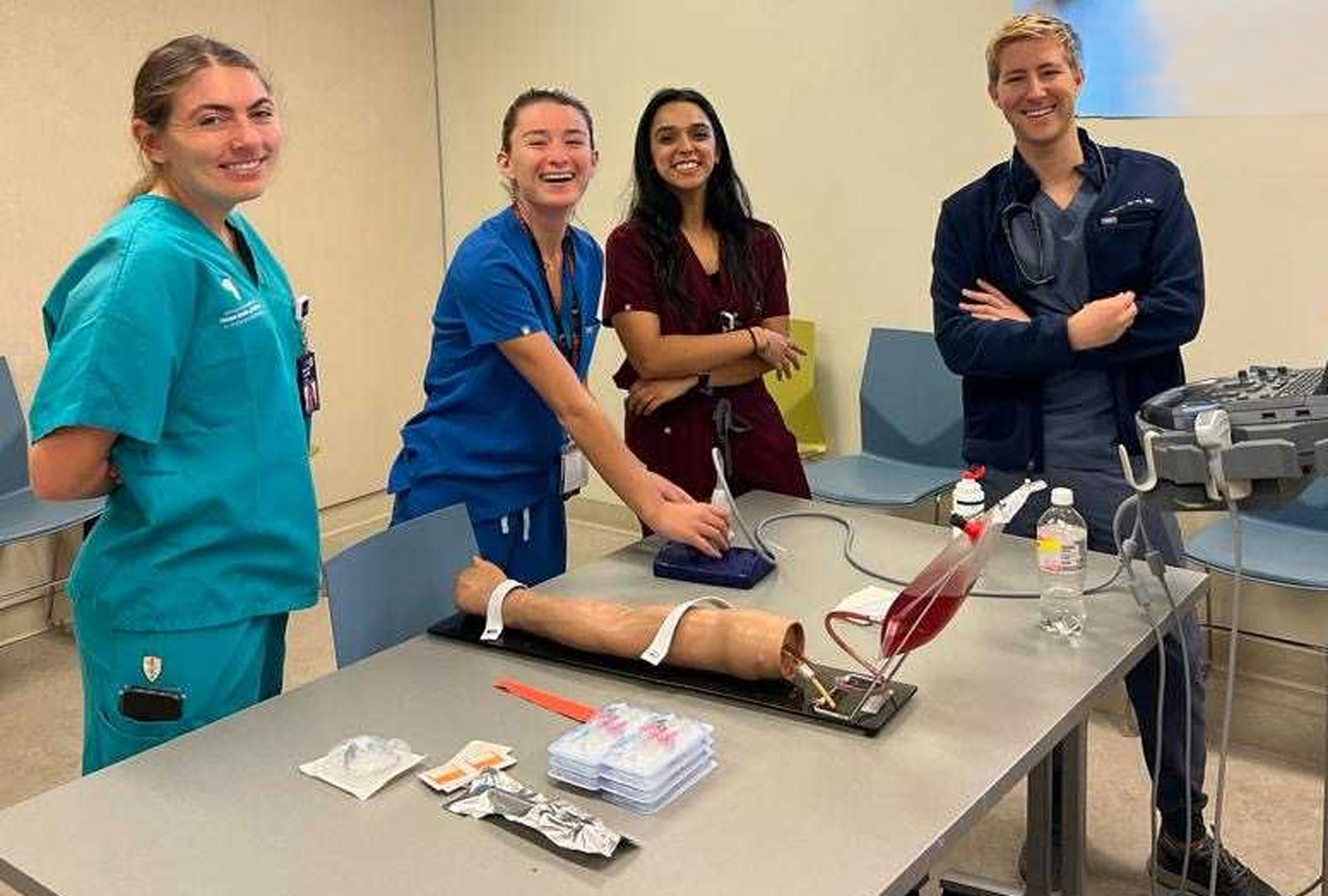 Four people wearing scrubs