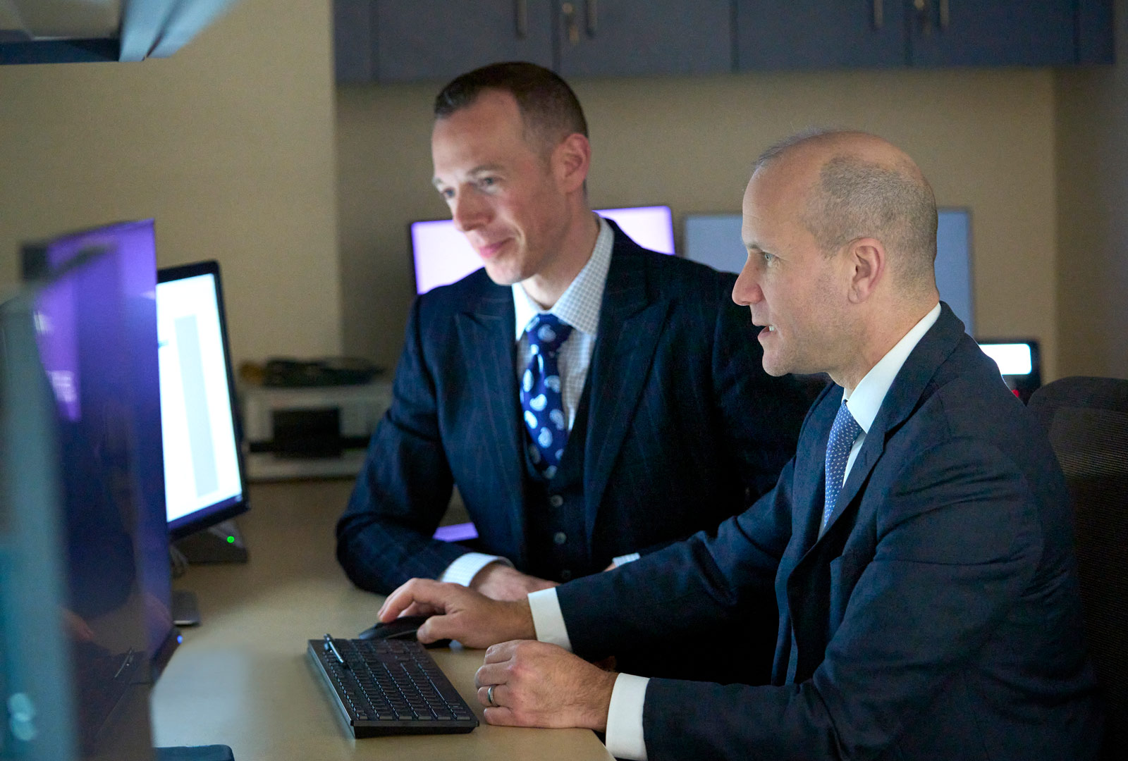 Two Radiation Oncologists review imaging results on computer.