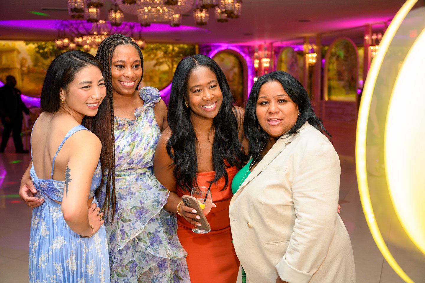 Two female residents and two female coordinators pose for the camera at the 2024 graduation ceremony.